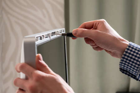 Close-up of a repairman fixing a computer.