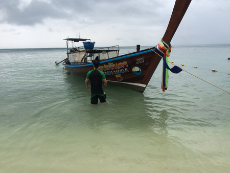A man with long-tailed boatの写真素材
