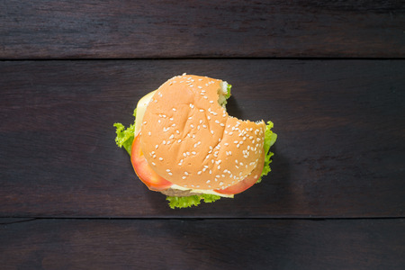 fast food with delicious bitten hamburger, shot from upper viewの写真素材