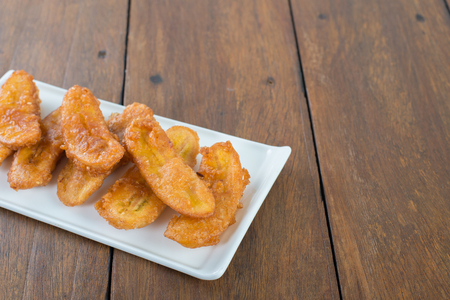 deep-fried sliced banana on wooden tableの写真素材