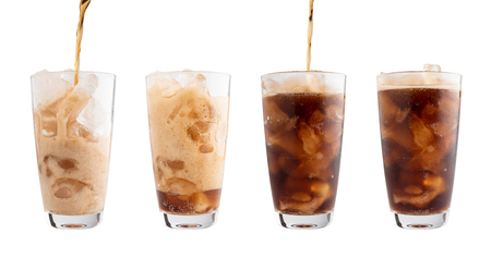Pouring soft drink into glass Isolated white backgroundの写真素材