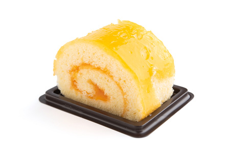 Orange roll cake on white background.の写真素材