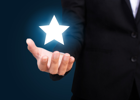 Success in Business or Personal Talent Concept. Happy business and Showing a Star in Hand.の写真素材