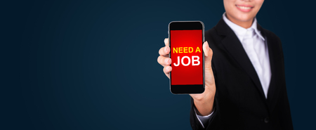 Need a job on smartphone screen in businesswoman hand.の写真素材
