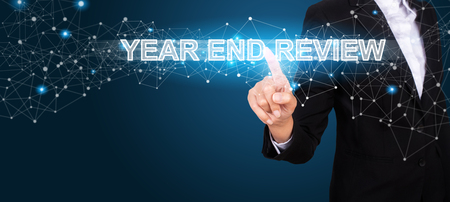 Year End Review concept with Hand of business pressing a button Year End Review.の写真素材