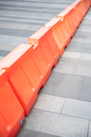 Red plastic barriers blocking the roadの写真素材