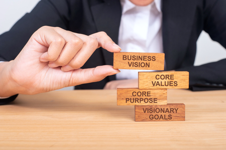Business hand building Vision business concept with wooden blocks.の写真素材