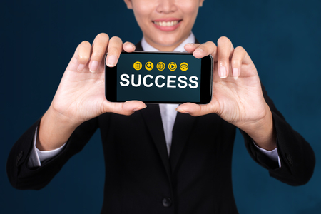 Success concept, Happy businesswoman Show text Success on smart phone.の写真素材