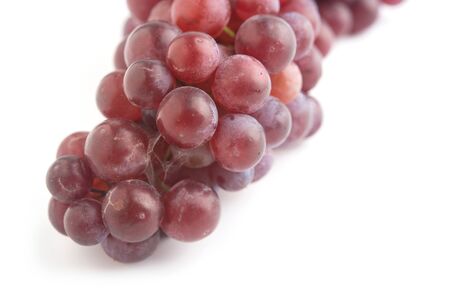 Close up fresh red and purple grape on whiteの写真素材