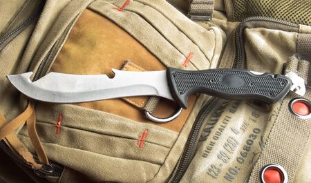 Army knife on a marching backpack backgroundの写真素材