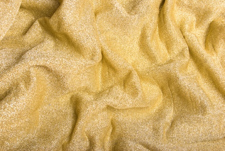 The golden metallized fabric with folds backgroundの写真素材