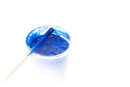 Jar with a blue paint and a brush, are isolated on a white backgroundの写真素材