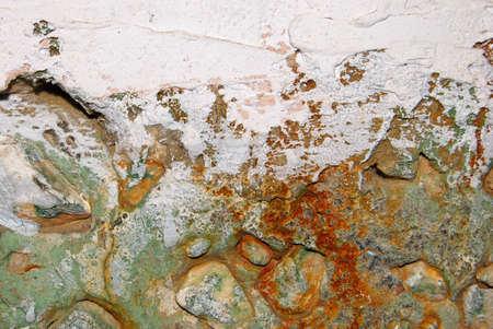 Concrete green wall with stones and the rustの写真素材