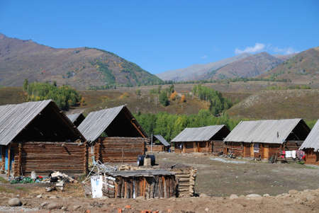 Xinjiang, China, autumn grasses and town の写真素材