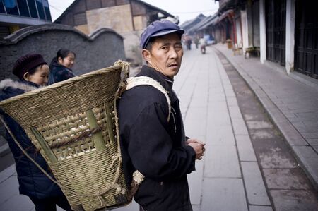 SICHUAN,CHINA - FEBRUARY 17: Unknown the old man into the city business, and because the city transformation, farmers lose arable land, switching to do businessï¼ February 17, 2011,Sichuan, Chinaのeditorial素材