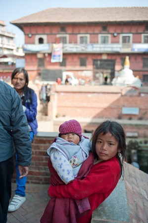 Katmandu, Nepal-January 29, 2012, : don't know the name of the Nepal children, in the temple square to have a rest, Nepal people have a deep belief in Buddhism, Kathmandu, 2012のeditorial素材