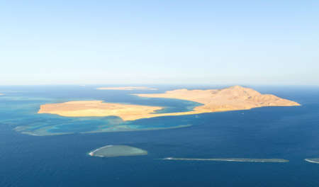 This photograph shows an uninhabited island in the oceanの写真素材
