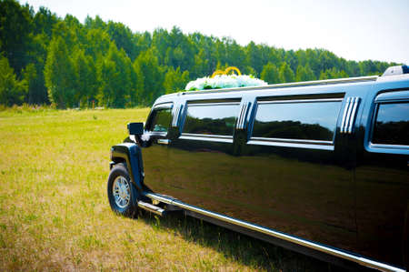 black limousine adorned with wedding ringsの写真素材