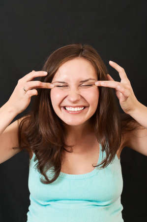 portrait of a beautiful young girl on a black backgroundの写真素材