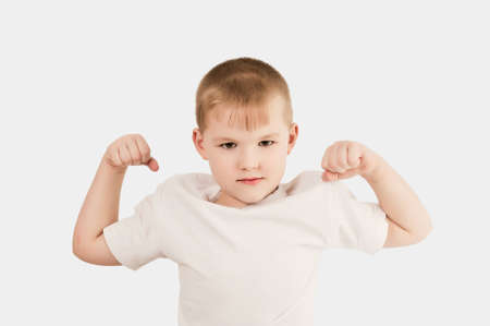 Child showing the muscle of his armの写真素材