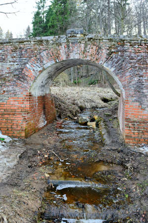 Garbage in river under bridge の写真素材