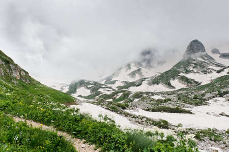 snow and grass in the North Caucasus mountains. Russia.の写真素材
