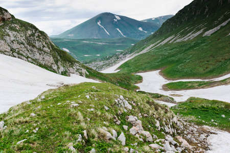 snow and grass in the North Caucasus mountains. Russia.の写真素材