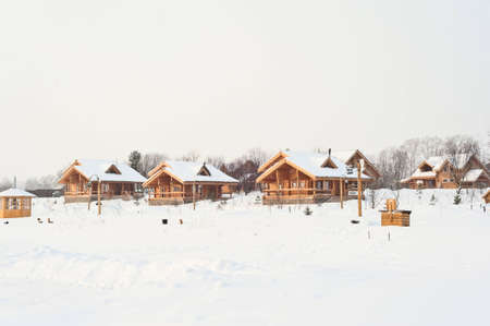 the photo shows a wooden house in the snowのeditorial素材