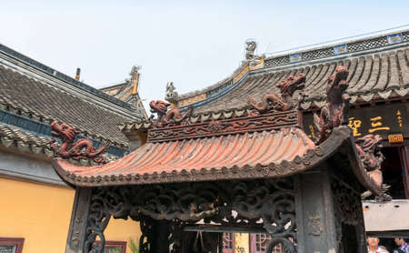 ZHOUZHUANG-AUGUST 19: Decorated Chinese dragon roof of the monastery in the village on the water , on August 19,2012, Zhouzhuang, Chinaのeditorial素材
