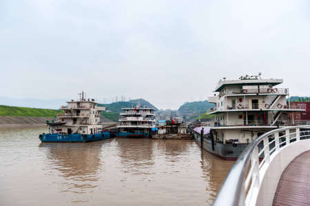 SANDOUPING-AUGUST 21: Chinese ships standing near Three Gorges Dam, on August 21,2012, Sandouping, Chinaのeditorial素材