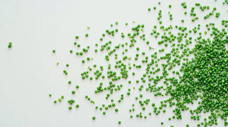Fresh green peas scattered on a light background, perfect for recipes and culinary presentation. A vibrant and healthy ingredient for various dishes.の素材