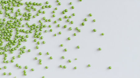 A vibrant display of fresh green peas scattered across a clean white surface, perfect for showcasing healthy eating, culinary styles, and natural ingredients.の素材