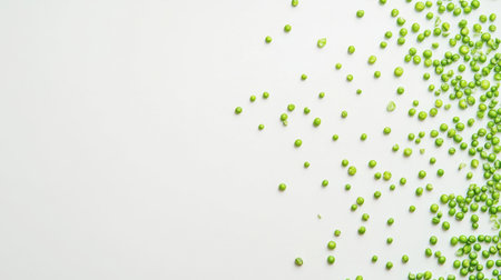 A vibrant display of fresh green peas scattered on a white surface, ideal for culinary inspiration and healthy meal preparations. Perfect for food photography.の素材