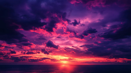Dark purple and fiery red clouds floating over the sky as the last rays of sunlight vanishの素材
