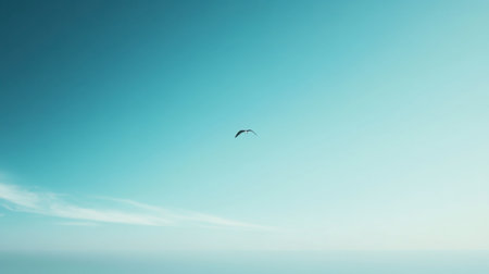 A clear blue sky with no clouds, featuring a single soaring bird in the distance, creating a sense of freedom.の素材