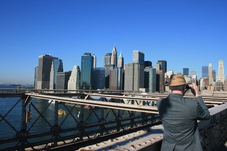 New York City, USA - October 15th, 2008 - Man taking pictures on the Brooklyn Bridge.のeditorial素材