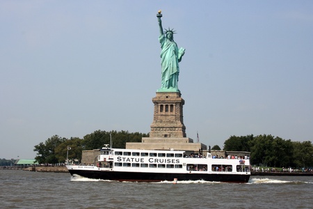 New York City, USA - September 3, 2011 - A cruise ship passing in font of the Statue of Liberty.のeditorial素材
