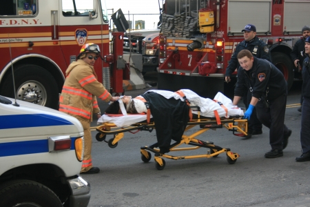 New York City, USA - January 9, 2013 - Injured person being brought to an ambulance by FDNY following a ferry crash.のeditorial素材