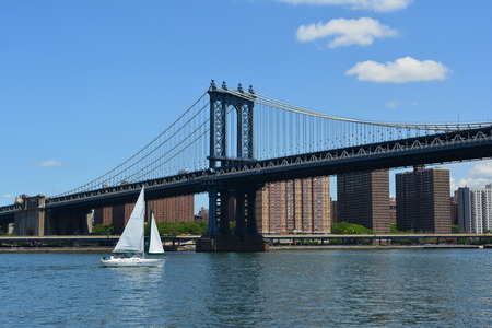 New York City, USA - June 6, 2014 - Boat on the East River passing under the Manhattan Bridge のeditorial素材