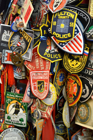 New York City, USA - August 10, 2014 - Fire Department patches left at a 9 11 memorial at Saint Pauls Church across the street from Ground Zero のeditorial素材