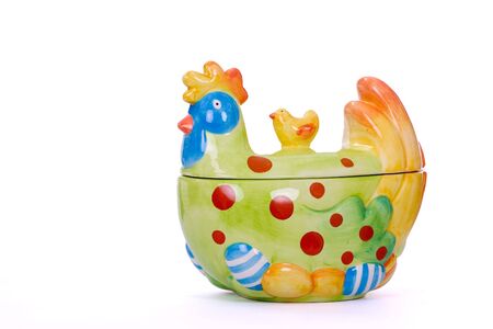 Funny porcelain chicken to keep eggs over white backgroundの写真素材