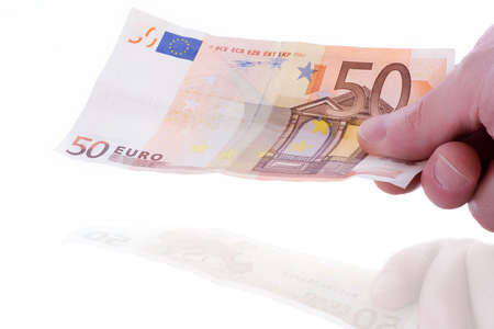 Hand holding a bank note with reflection over white background