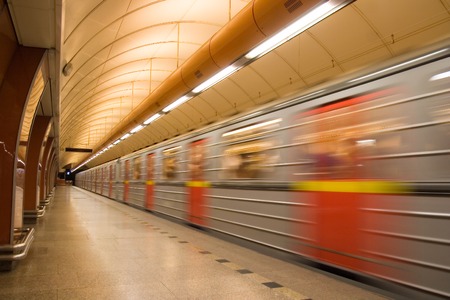 Subway station platform with train passing byの写真素材