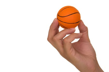 Feminine hand holding miniaturized rubber basketball over white backgroundの写真素材