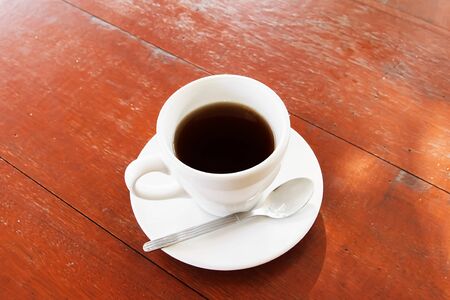 A cup of tea on tray with spoonの写真素材