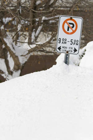 MARCH 9 2008: Snow drifts as high as the streetside parking signs after a heavy snow storm in Ottawa Ontario Canada.の写真素材
