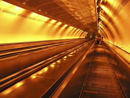 Escalator to subway station under neon lights.の写真素材