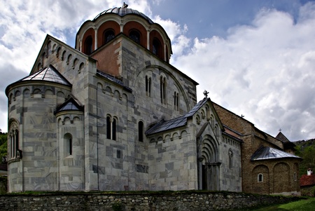 The most famous Serbian monastery with beautifull park and flowers at sunny summer day with clear...