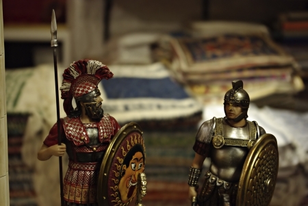 Shelf in antiquities shop with metal medieval crusades knight soldiers 