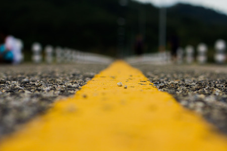 yellow line wiht asphalt road texture. close upの写真素材